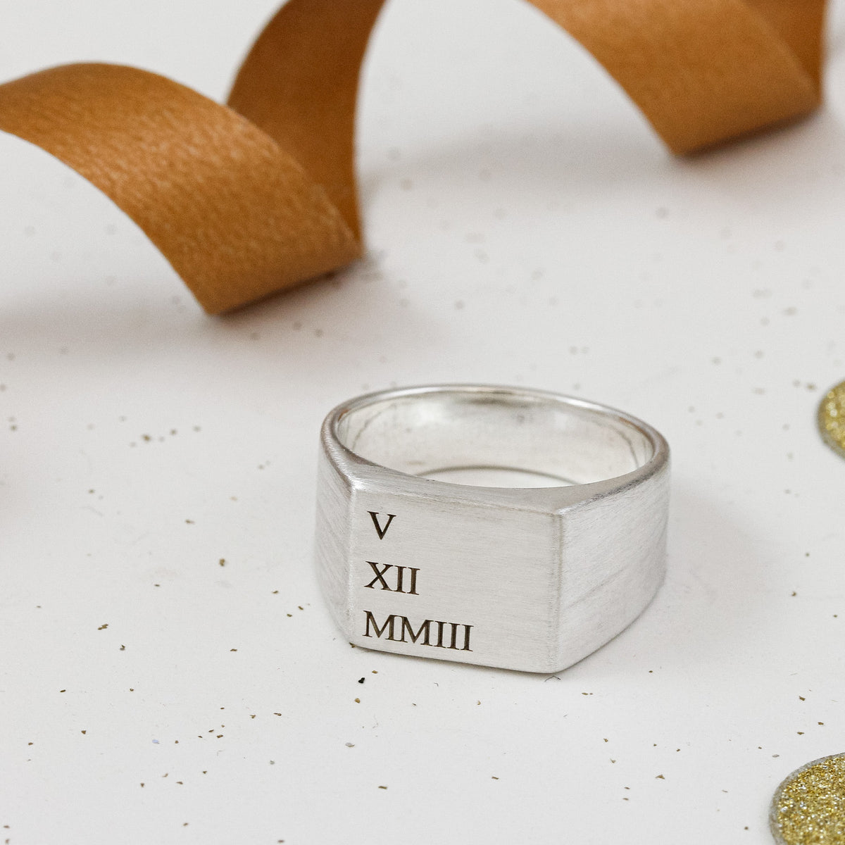 silver signet ring with roman numerals date engraved