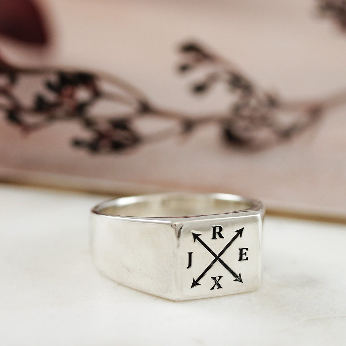 silver mans square signet ring engraved with four initials
