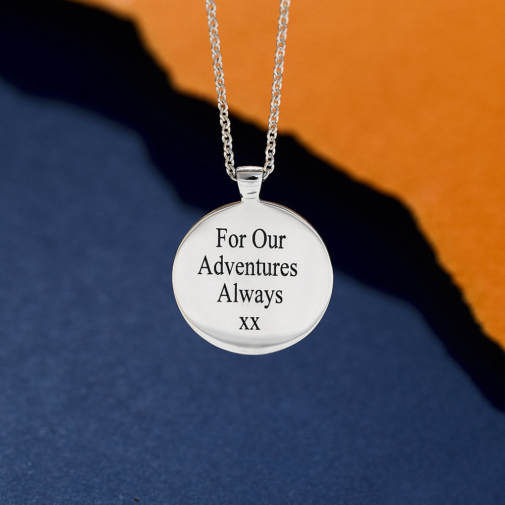 Silver necklace with a round pendant engraved back of street map