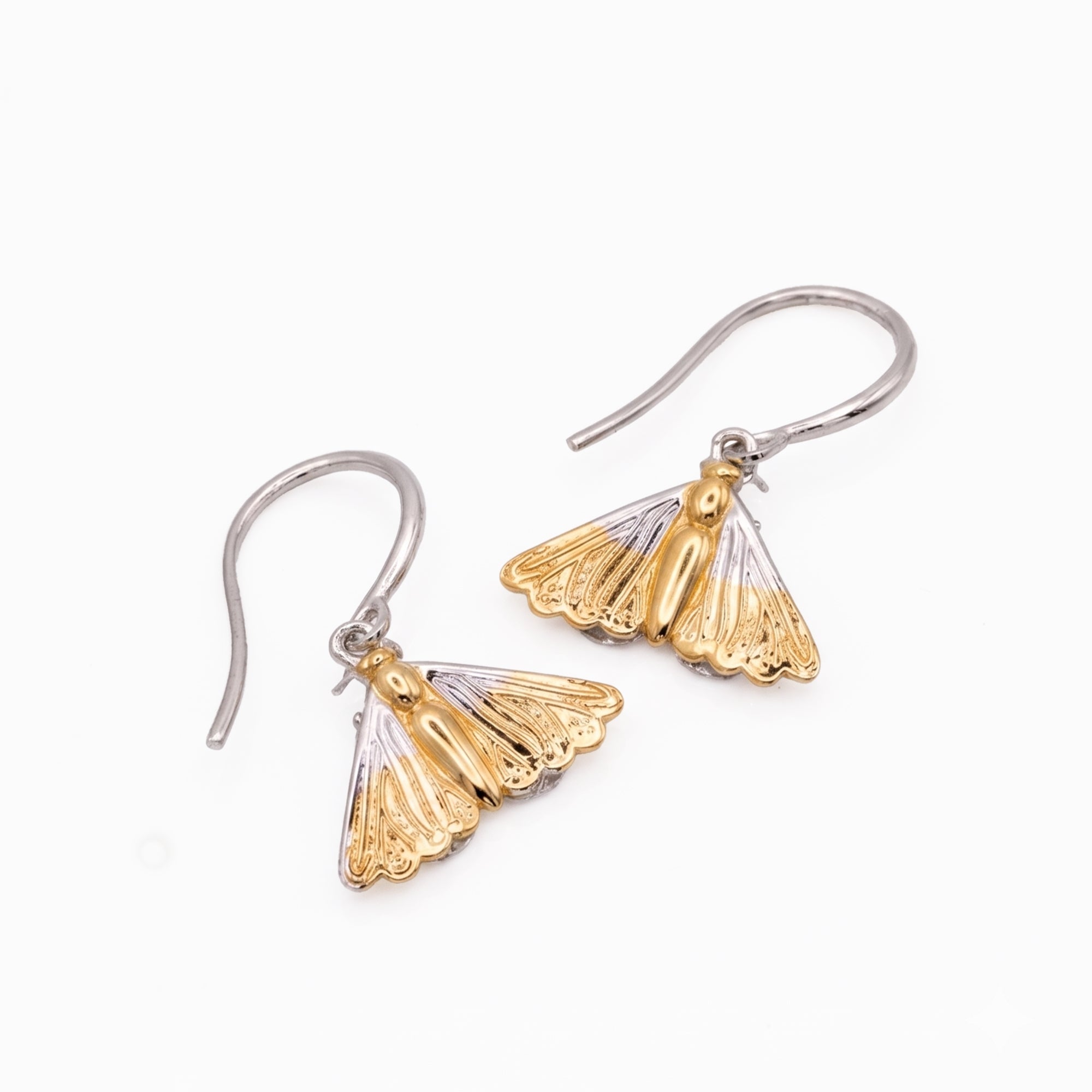 Gold and silver moth-shaped earrings on a white background
