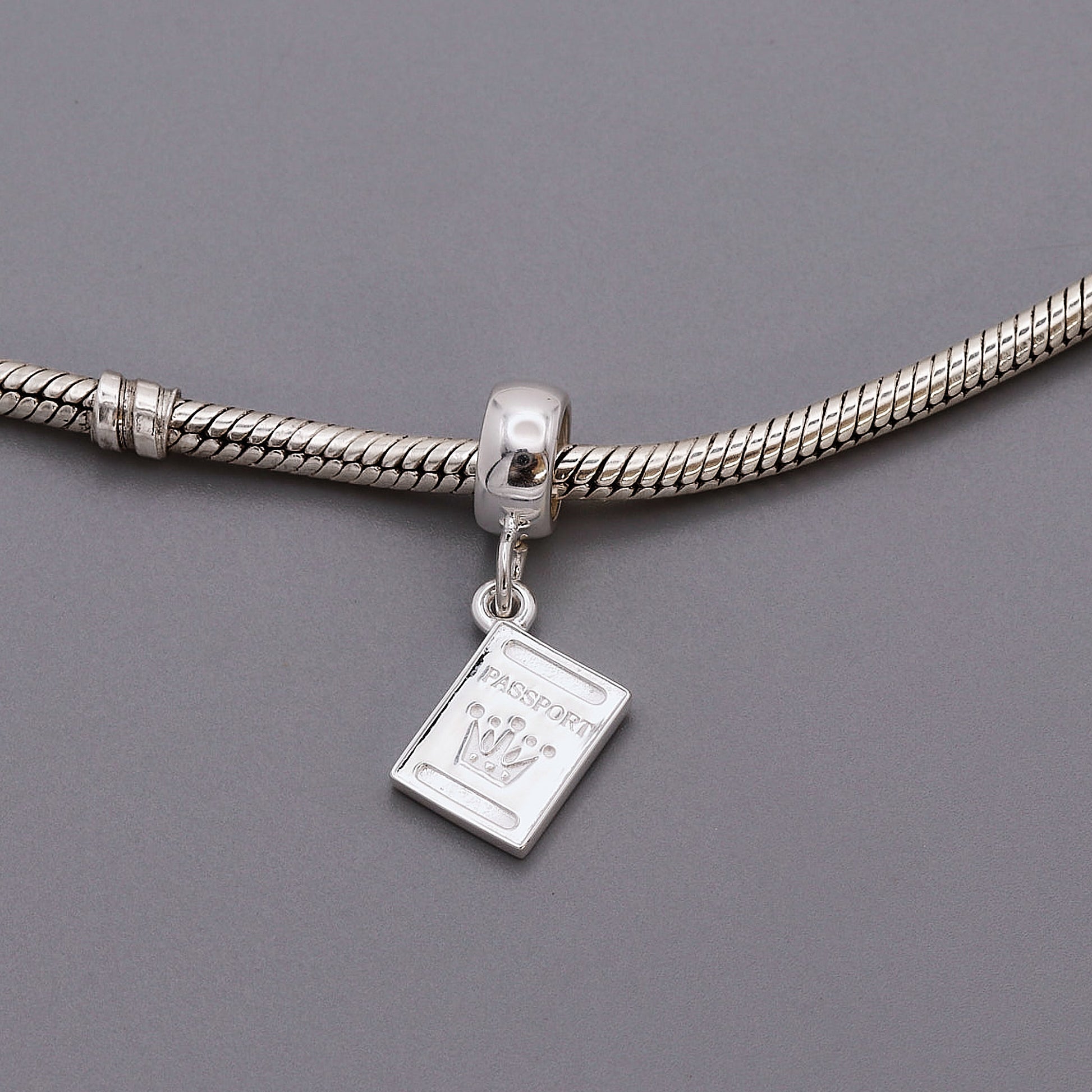 silver passport charm on pandora style bracelet
