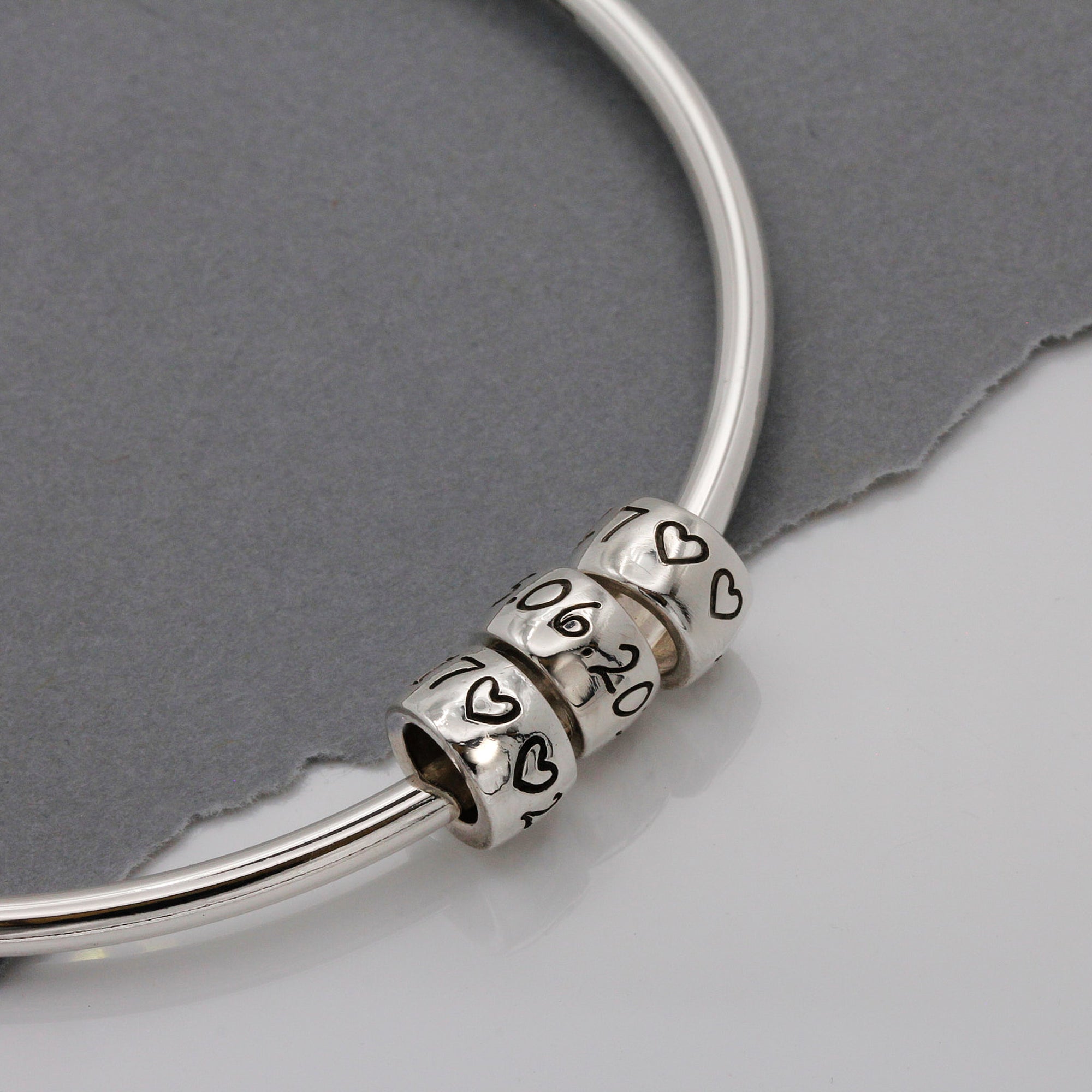 personalised charm beads on a silver bangle