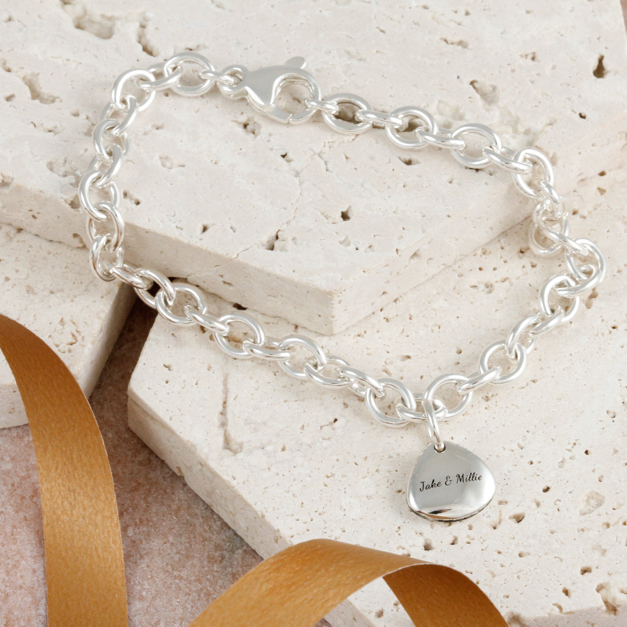 personalised reverse of paw print charm on a bracelet