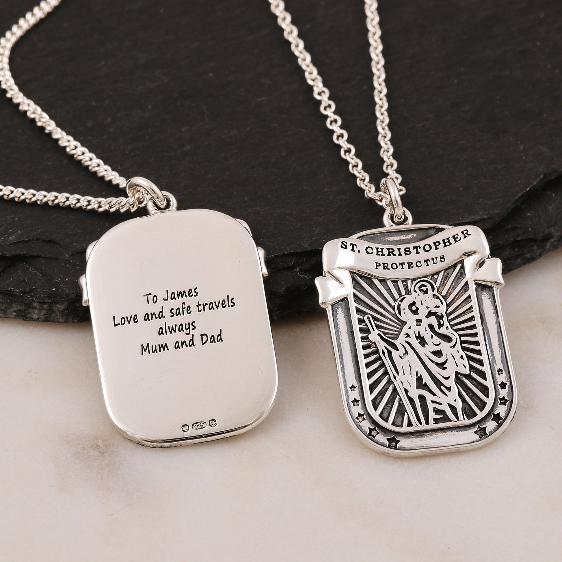 Silver saint christopher oxidised pendant with engraved text on a dark surface