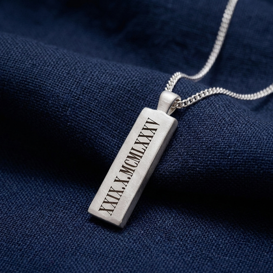 Silver pendant with Roman numerals on a dark blue fabric background