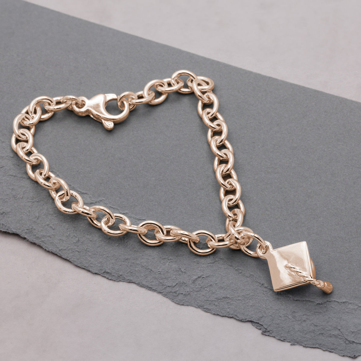 rose gold plated mortar board charm bracelet.jpg