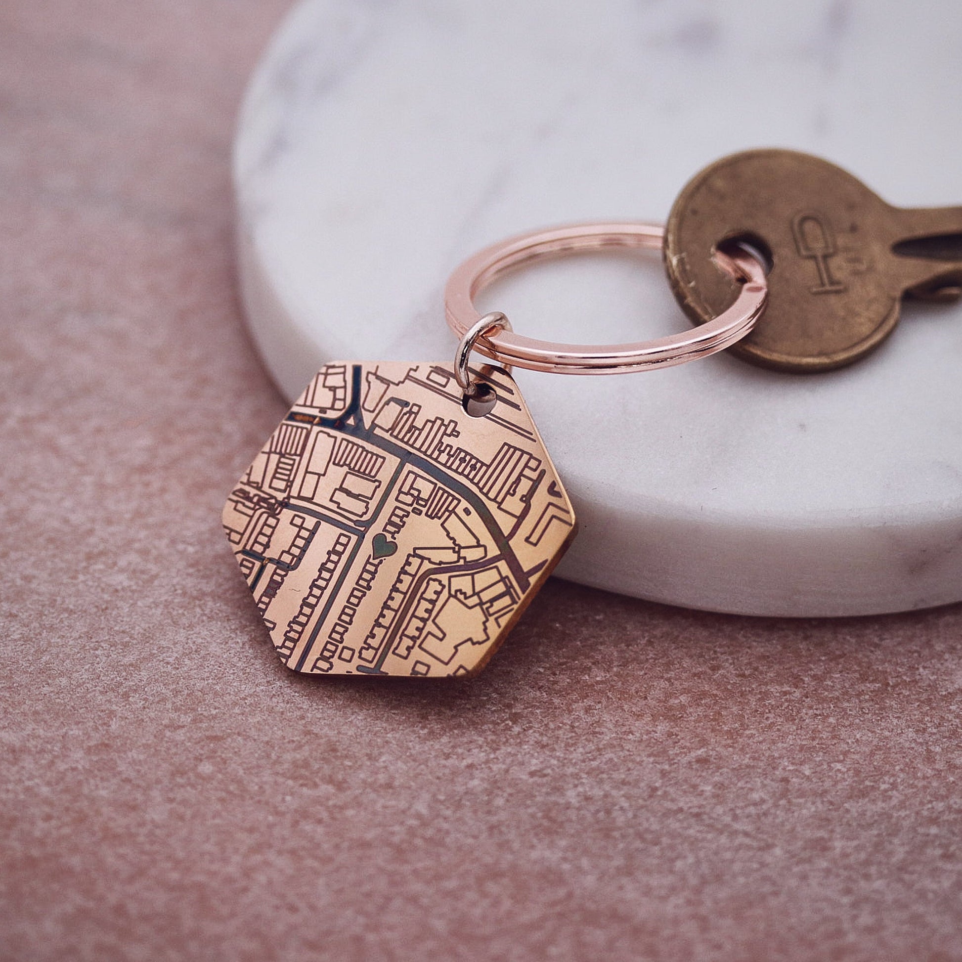 Keychain with engraved design on a marble surface