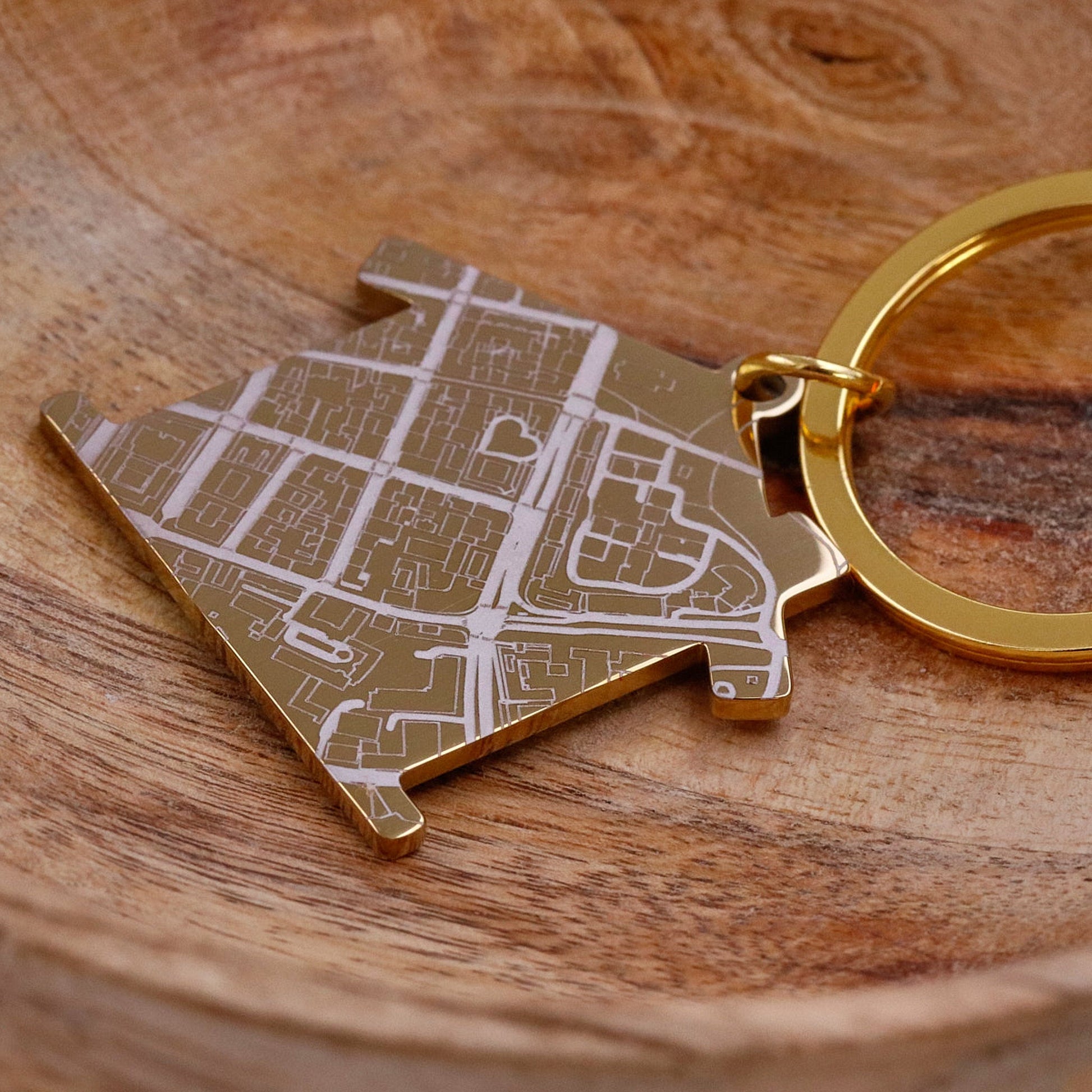 Gold house shaped silver keyring with map design