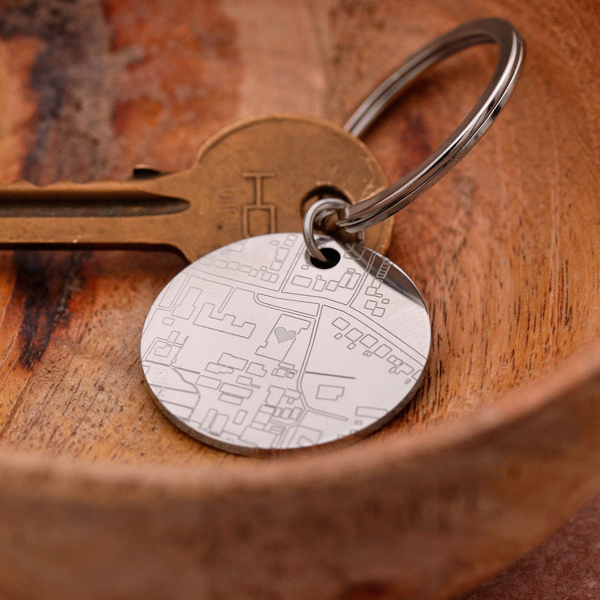 Keychain with a detailed map design on a wooden surface