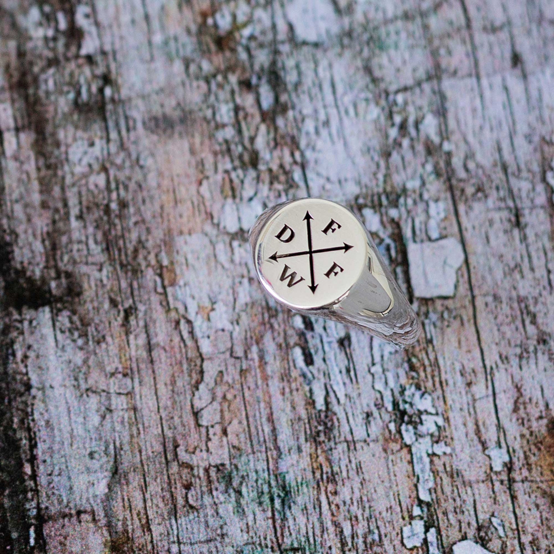 silver signet ring engraved with initials