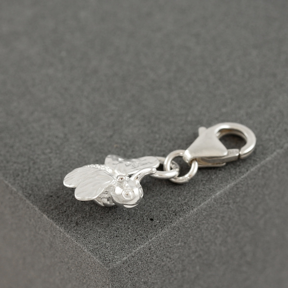 silver bee charm with clip on clasp and face detail