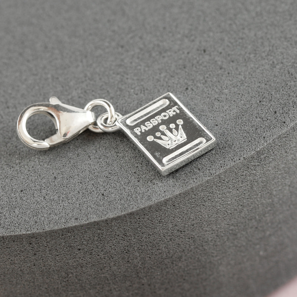 silver passport charm detail with clip on clasp