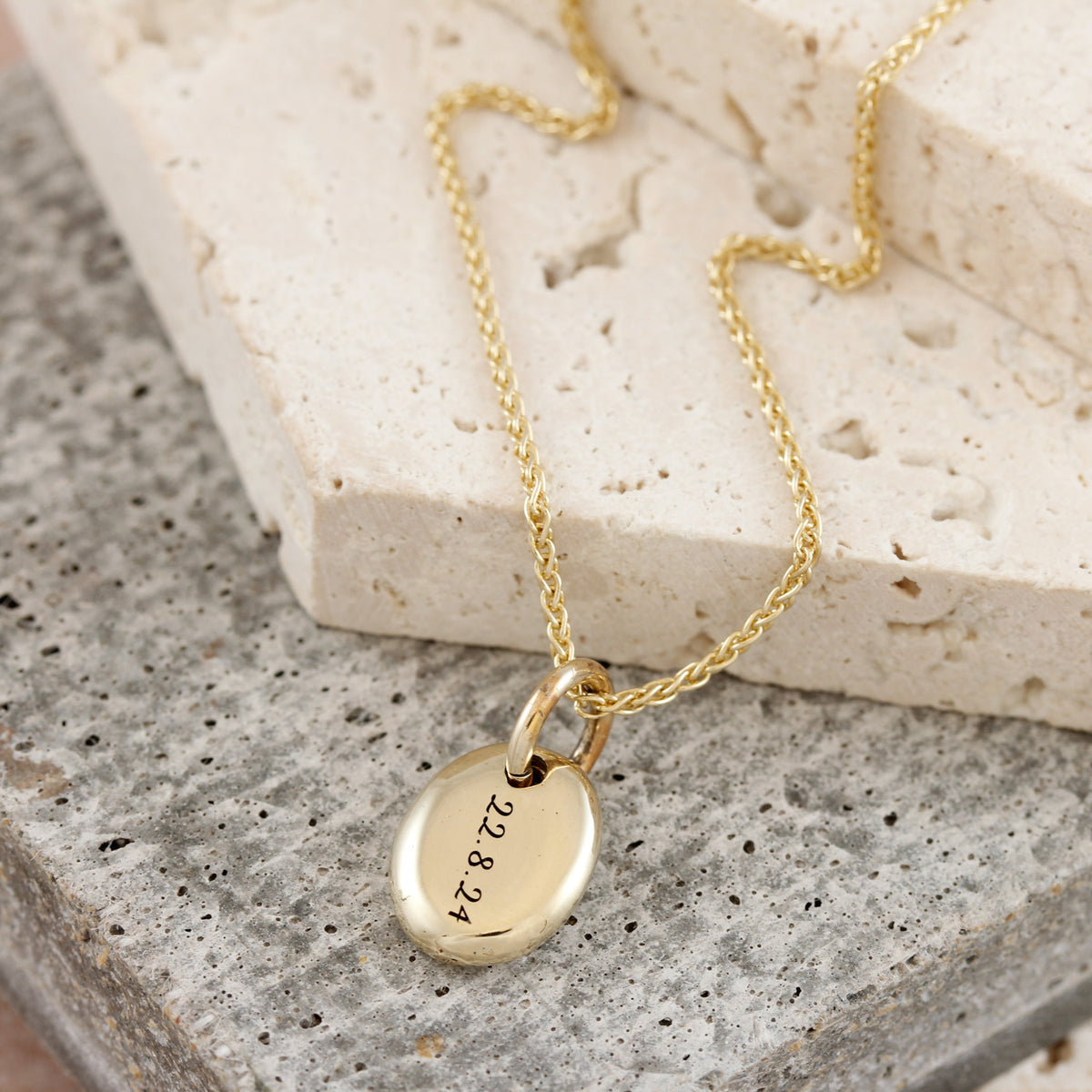 solid gold pebble necklace engraved with date