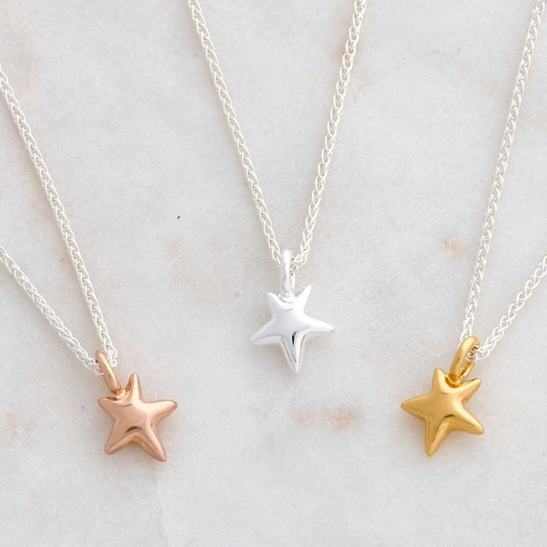 silver and solid gold rose gold star pendants