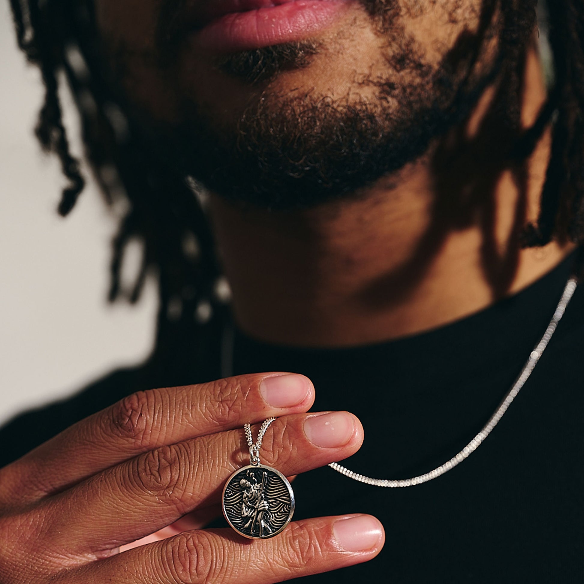 unusual storm guardian saint christopher necklace on curb chain oxidised finish