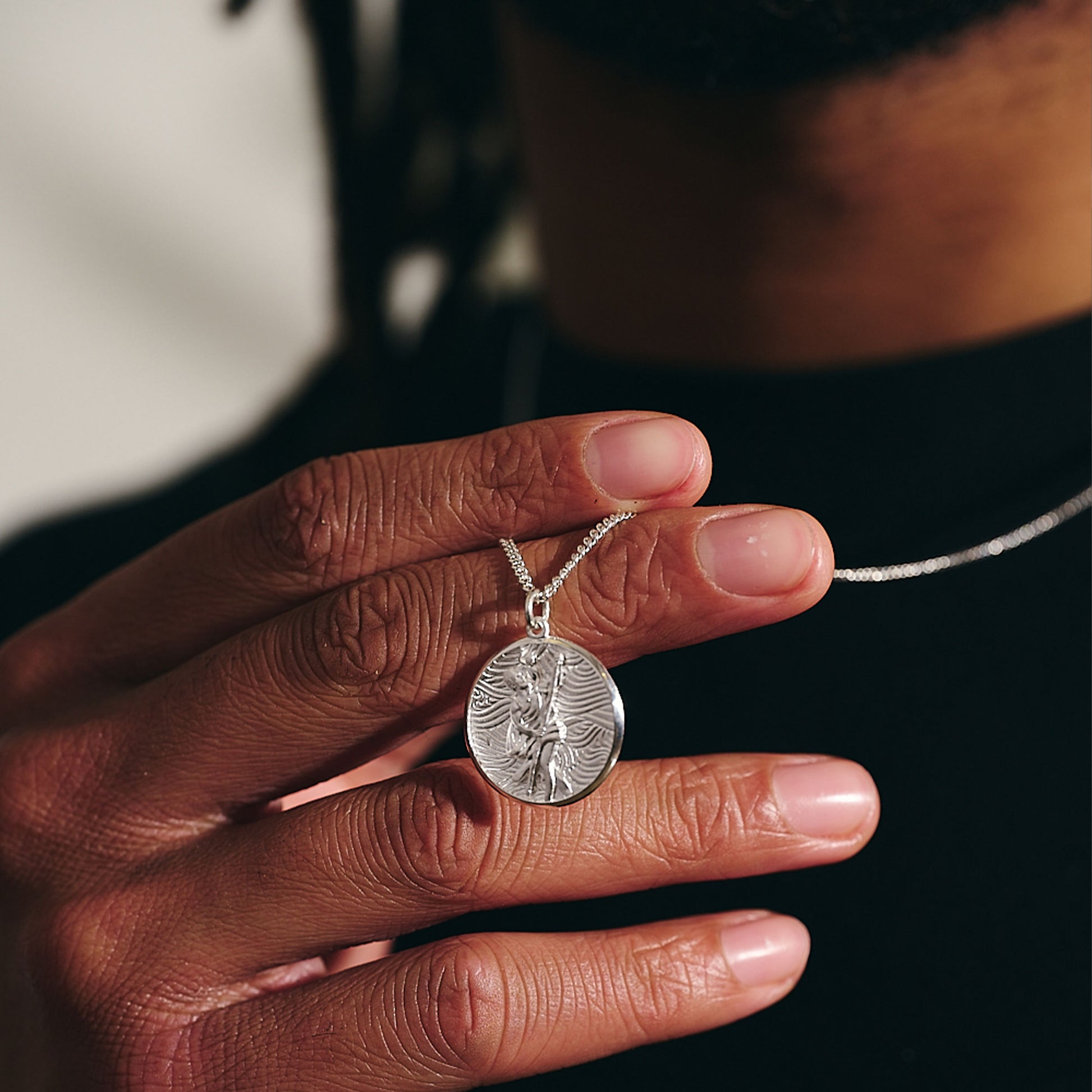 unusual storm guardian saint christopher necklace on curb chain polished finish