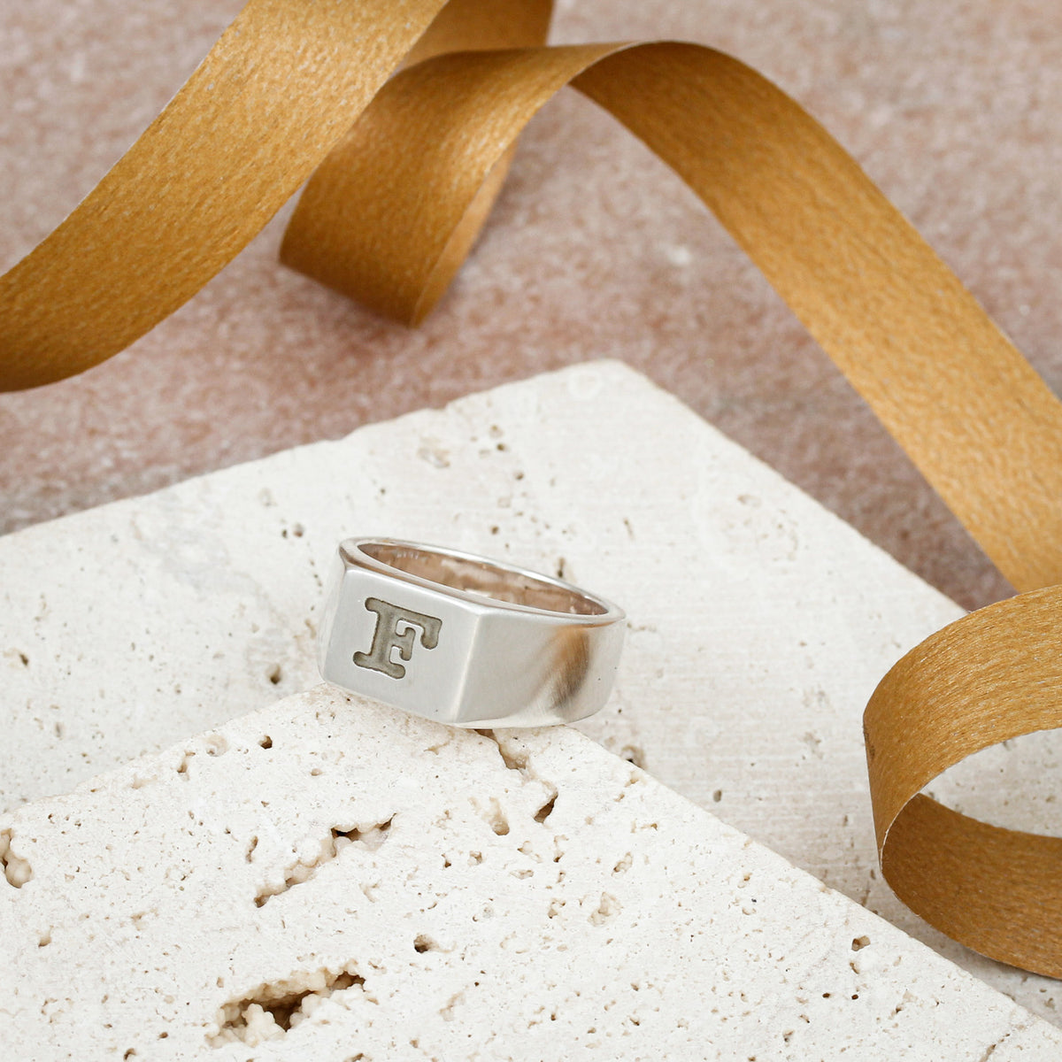 silver signet ring engraved with typewriter initial