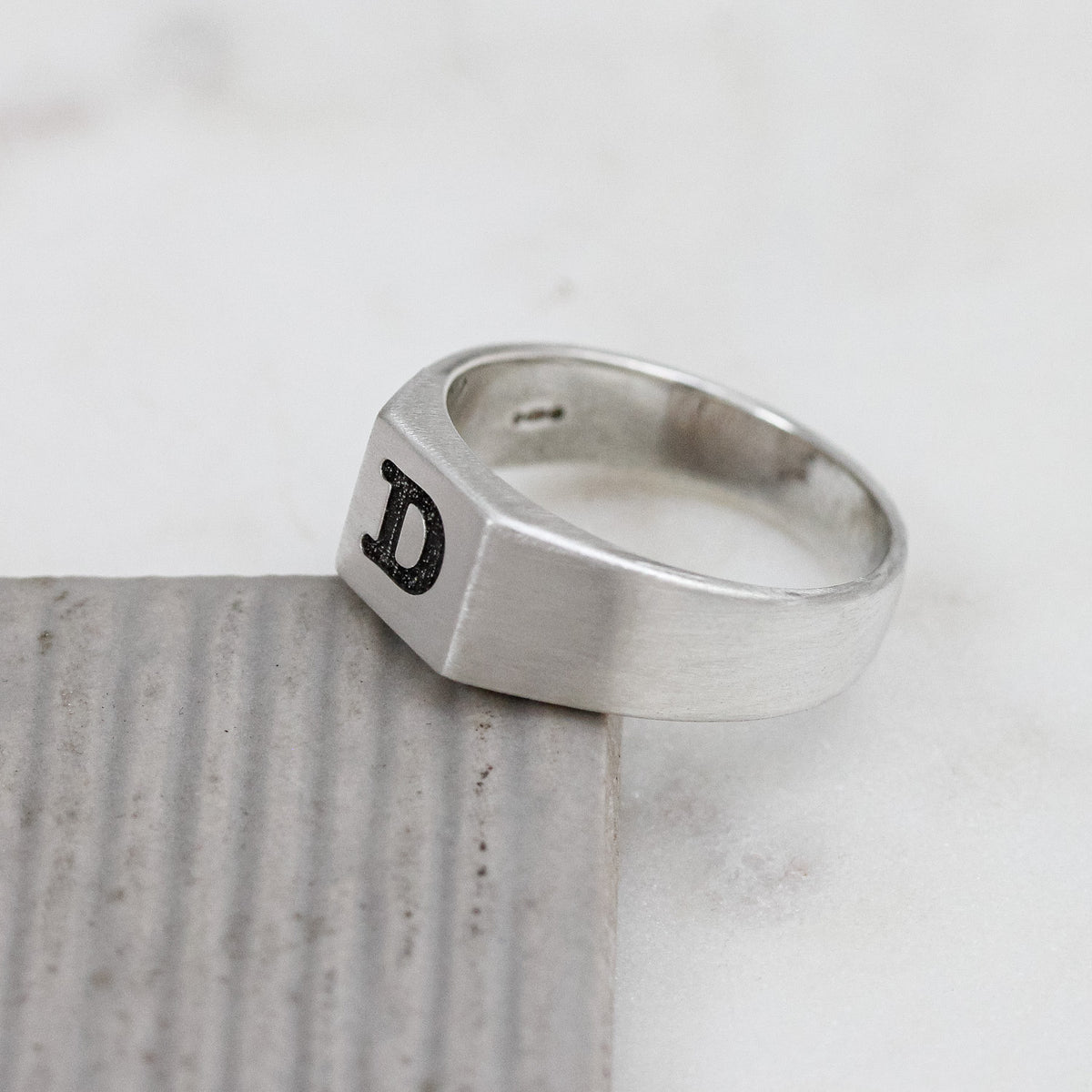 silver signet ring engraved with typewriter initial