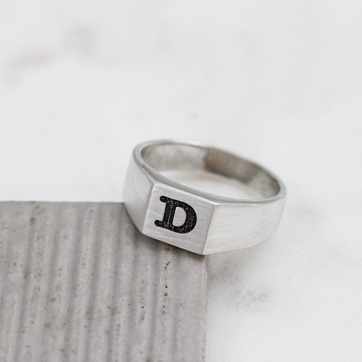 silver signet ring engraved with typewriter initial
