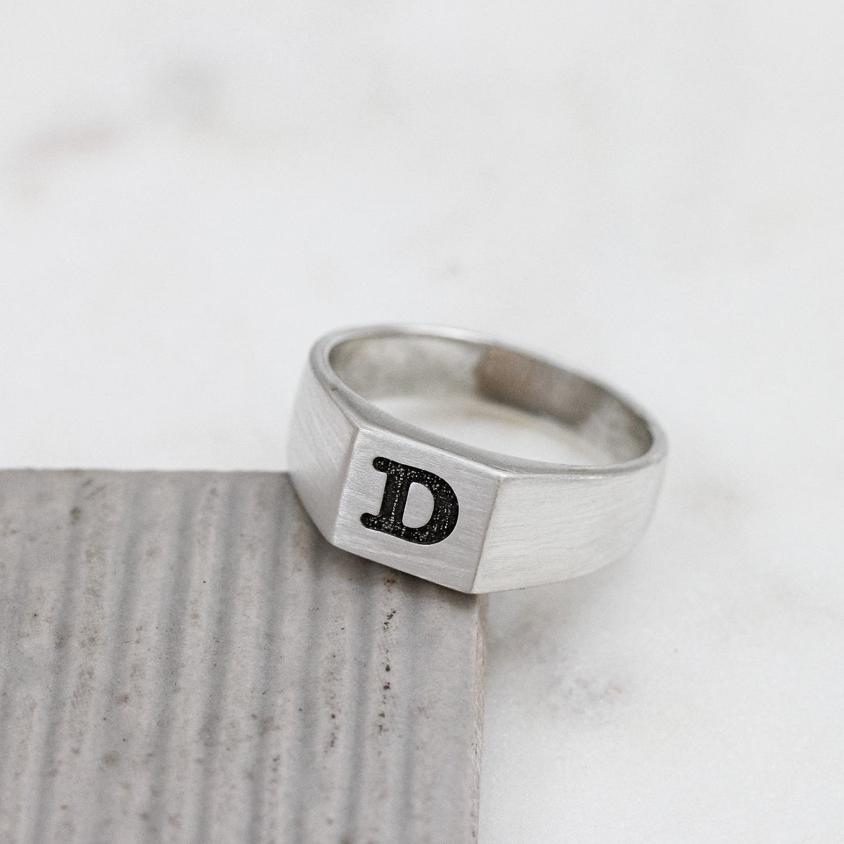 silver signet ring engraved with typewriter initial