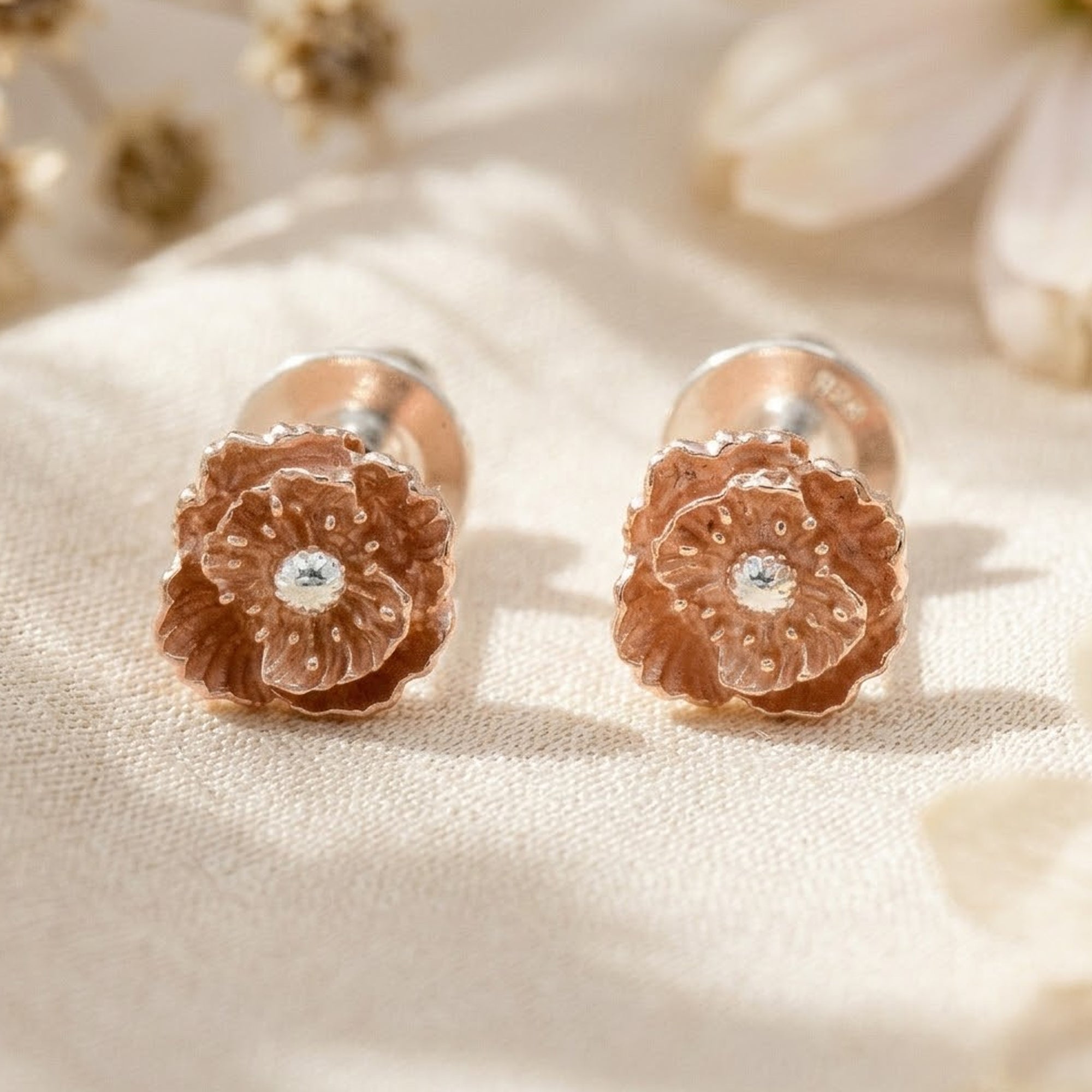 wild poppy flower stud earrings on fabric background