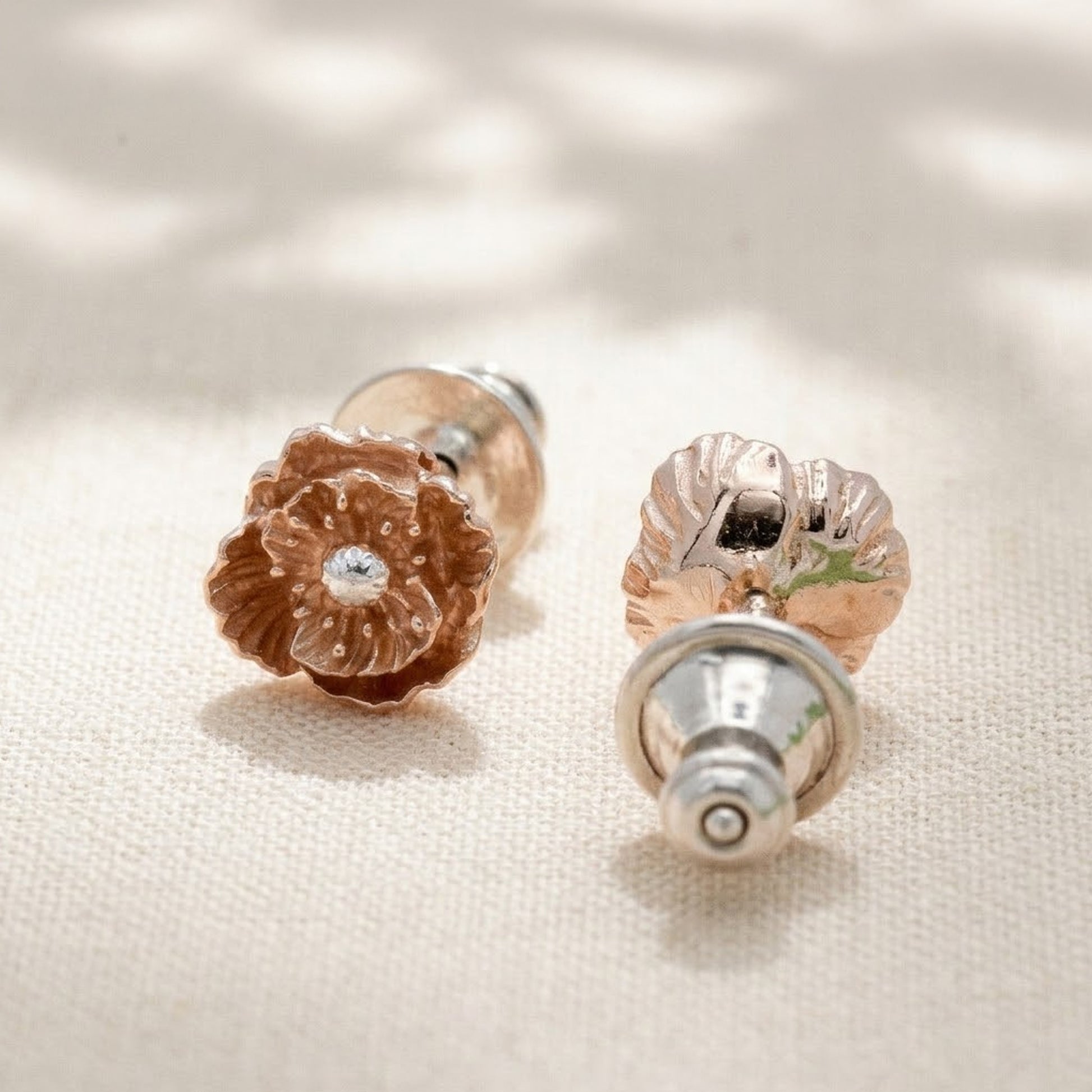 wild poppy flower stud earrings on fabric background