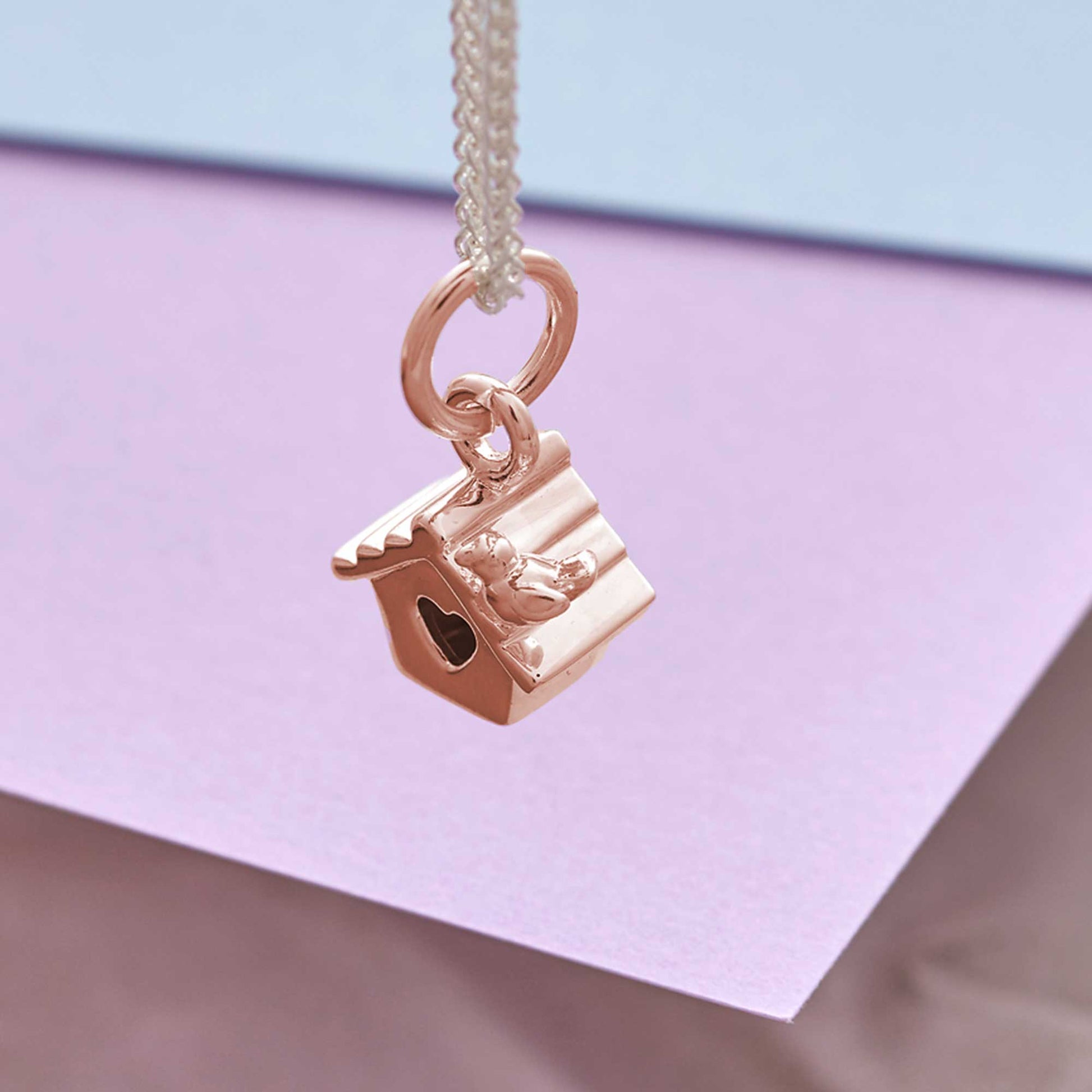 Rose Gold Bird house charm on silver necklace chain showing size and proportion