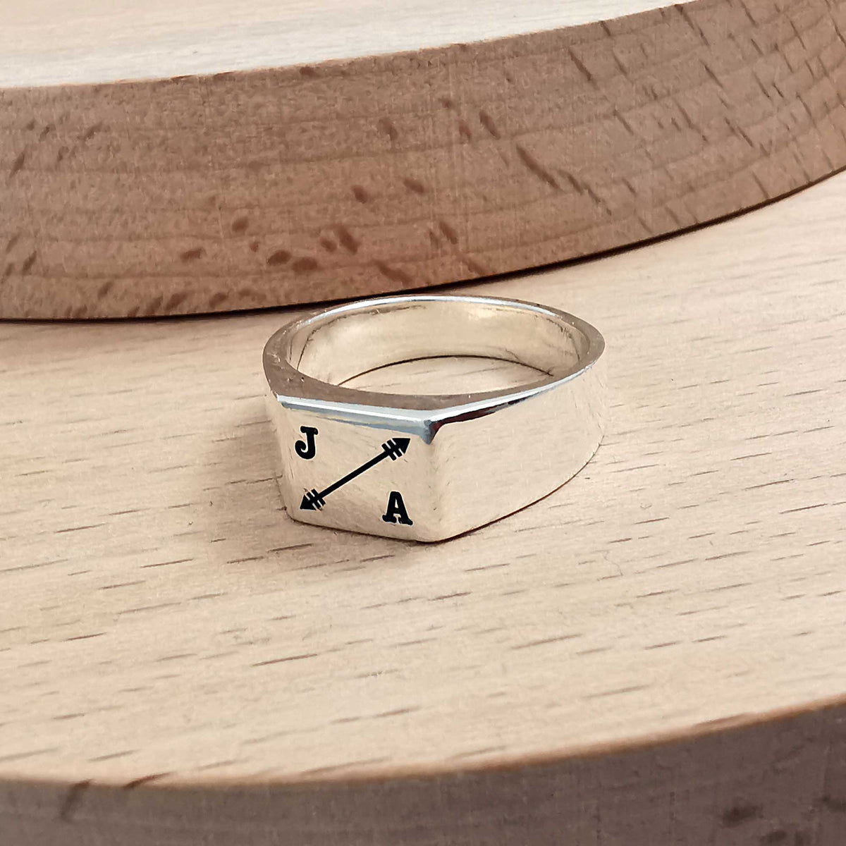mens signet ring engraved with initials and arrow symbol