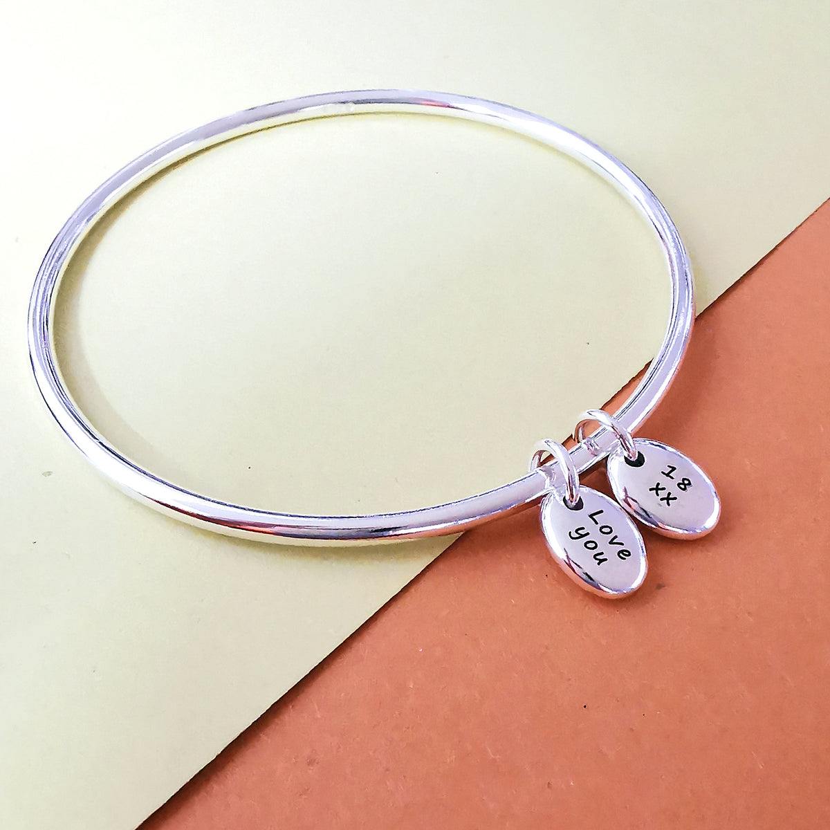 silver bangle with two personalised silver pebble charms for 18th birthday gift