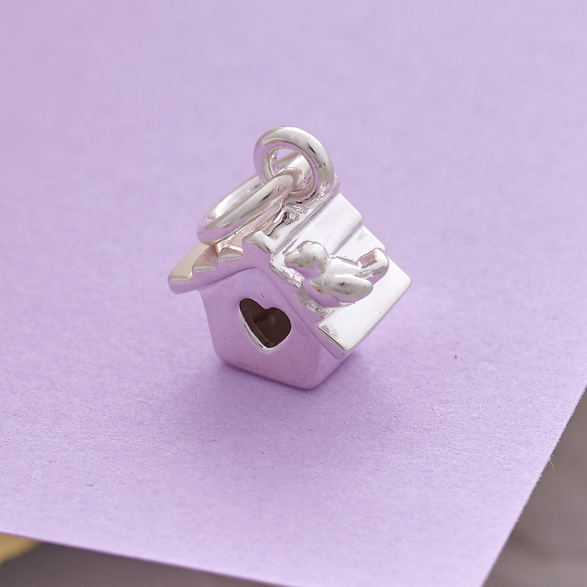 Sterling silver bird house charm showing heart-shaped entrance and detailed roof