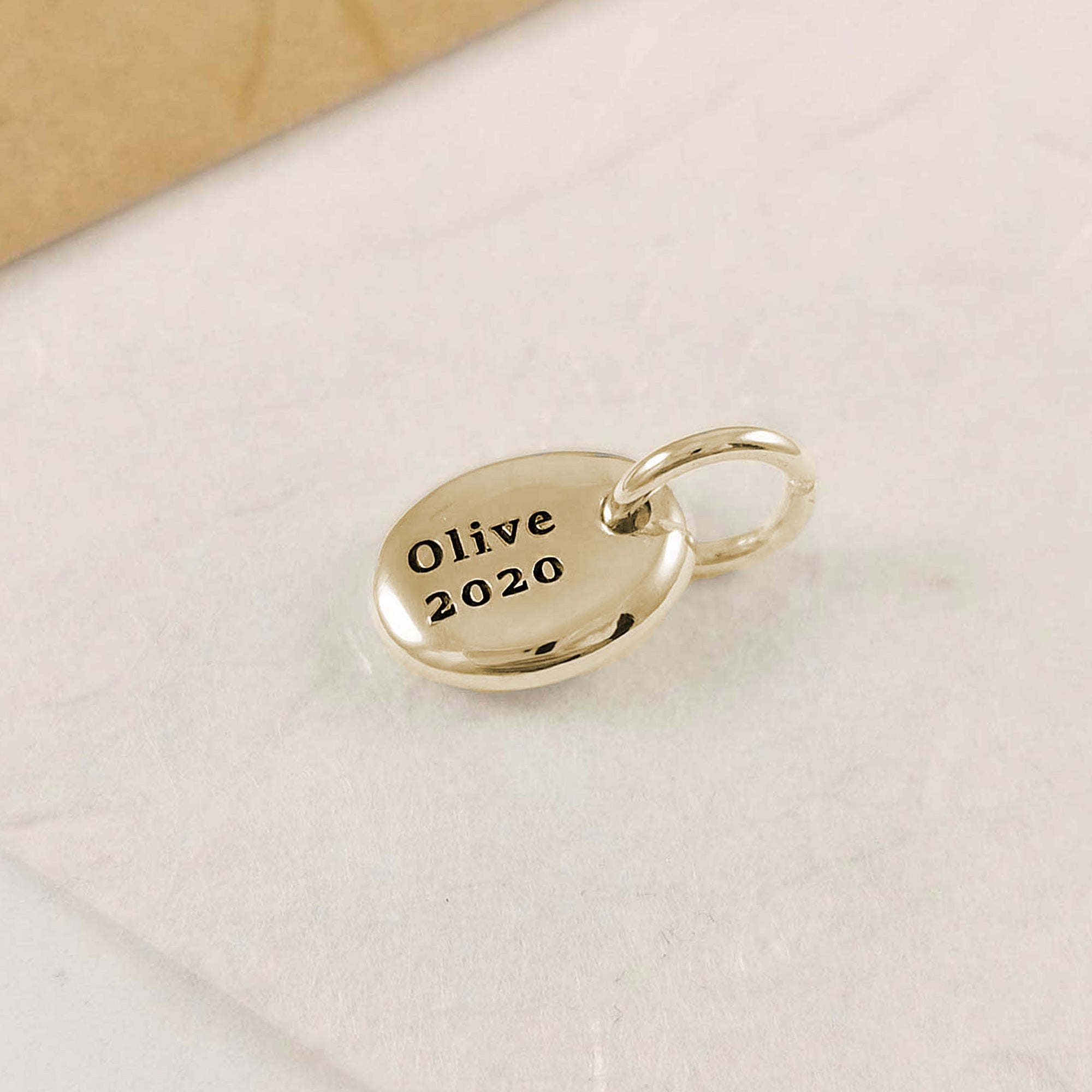 personalised solid gold pebble charm for a bracelet