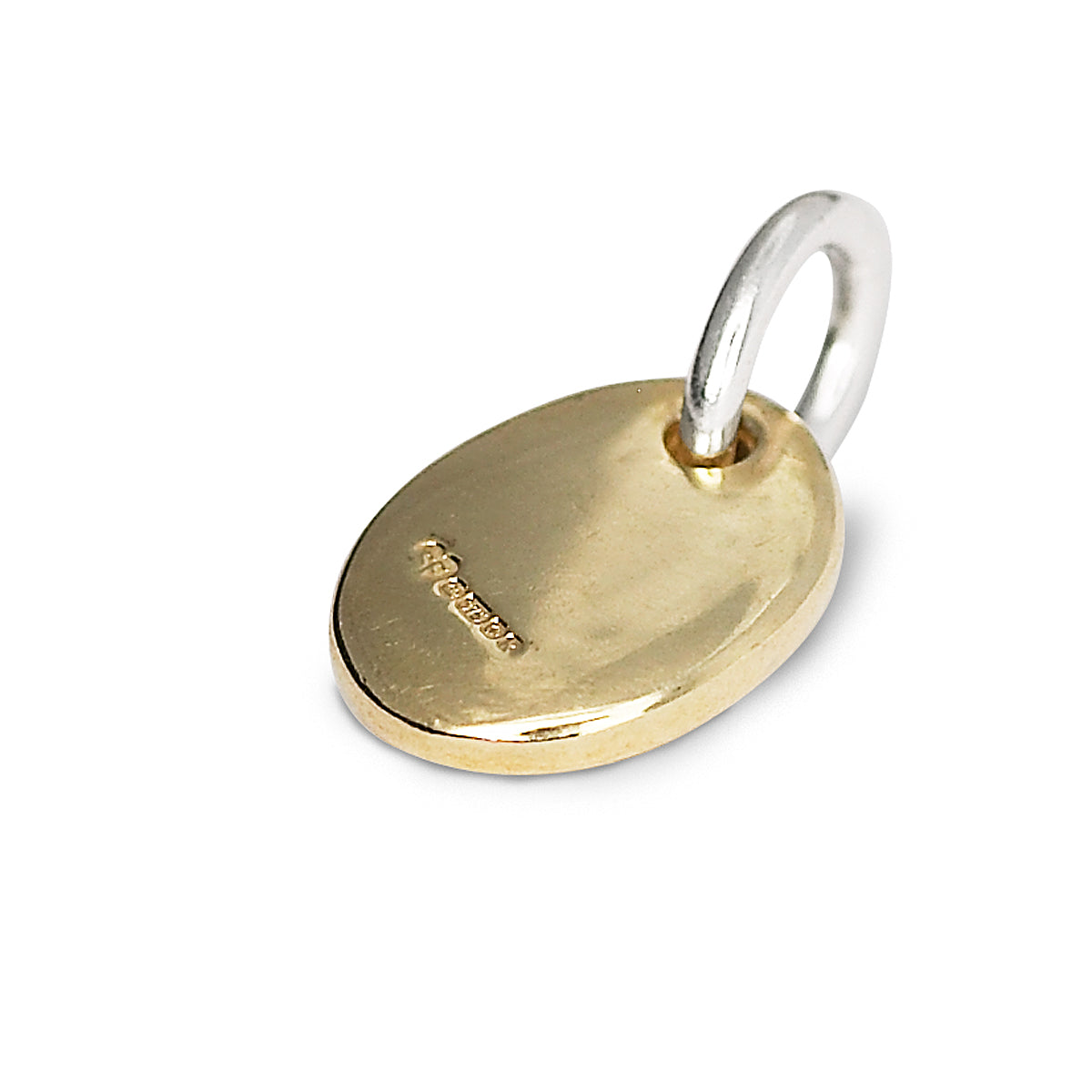 back of solid gold pebble charm on silver jump ring