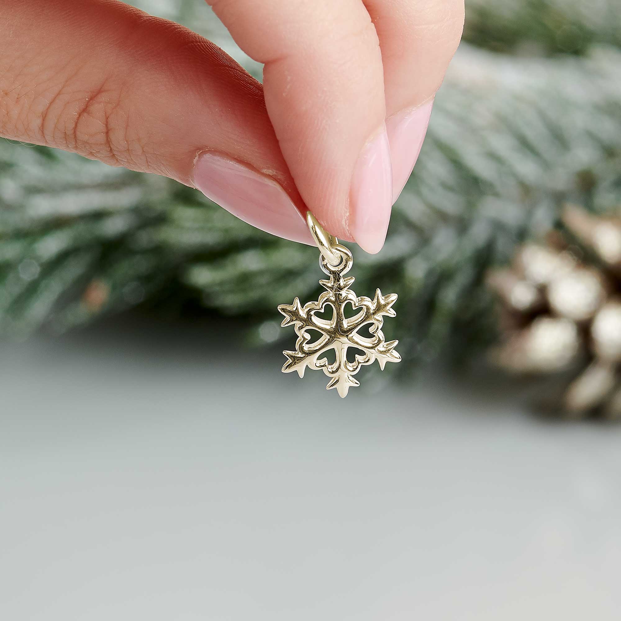 solid gold snowflake charm with gold jump ring