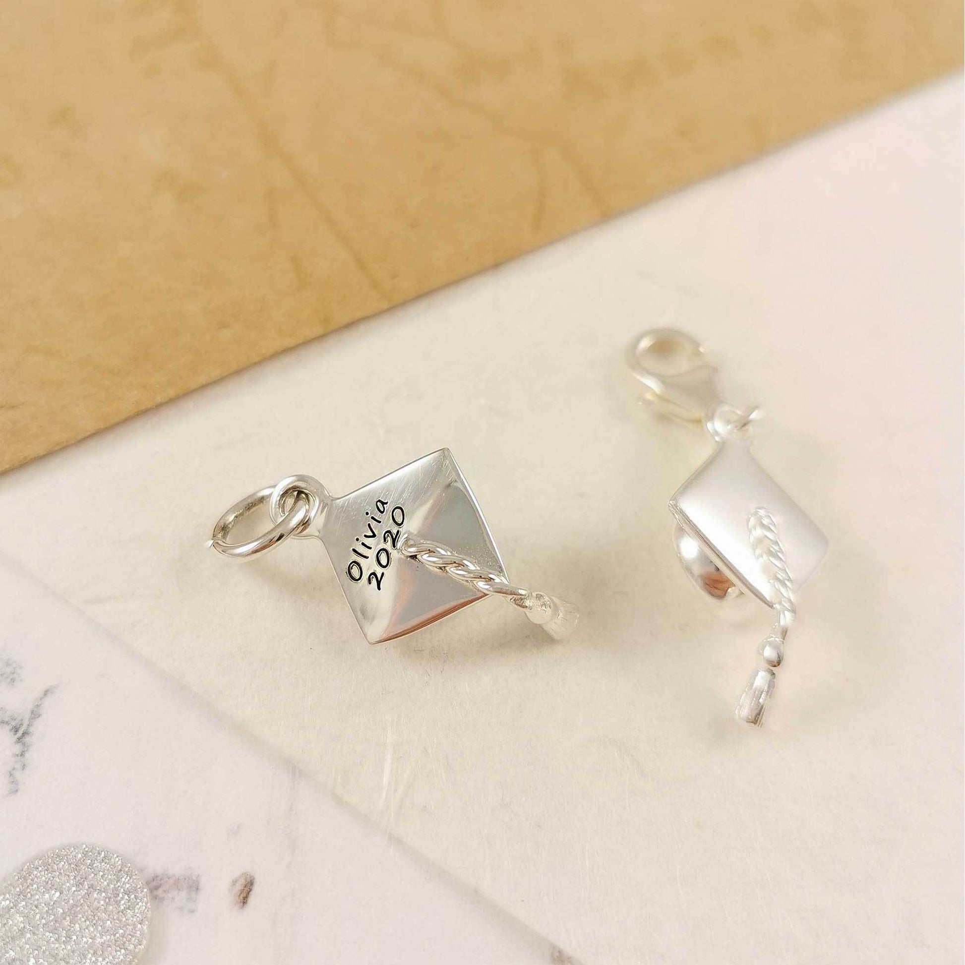 graduation cap silver charm engraved with name of graduate