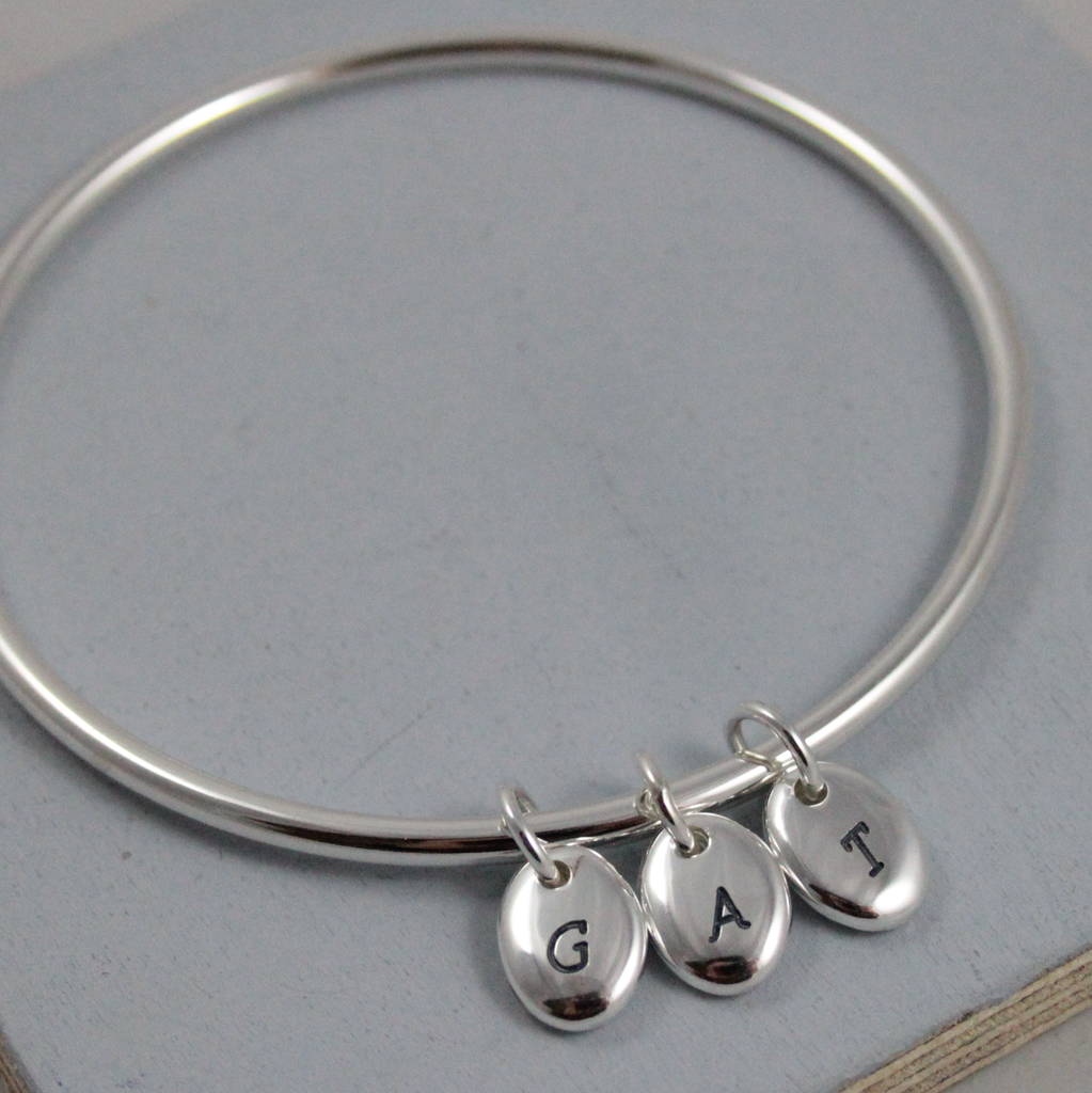 silver bangle with three personalised silver pebble charms for mothers day gift
