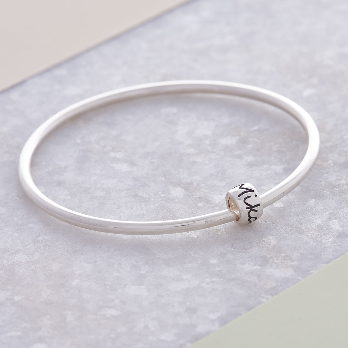 Personalised Silver Engraved Charm Bead Designer Charms on a silver bangle