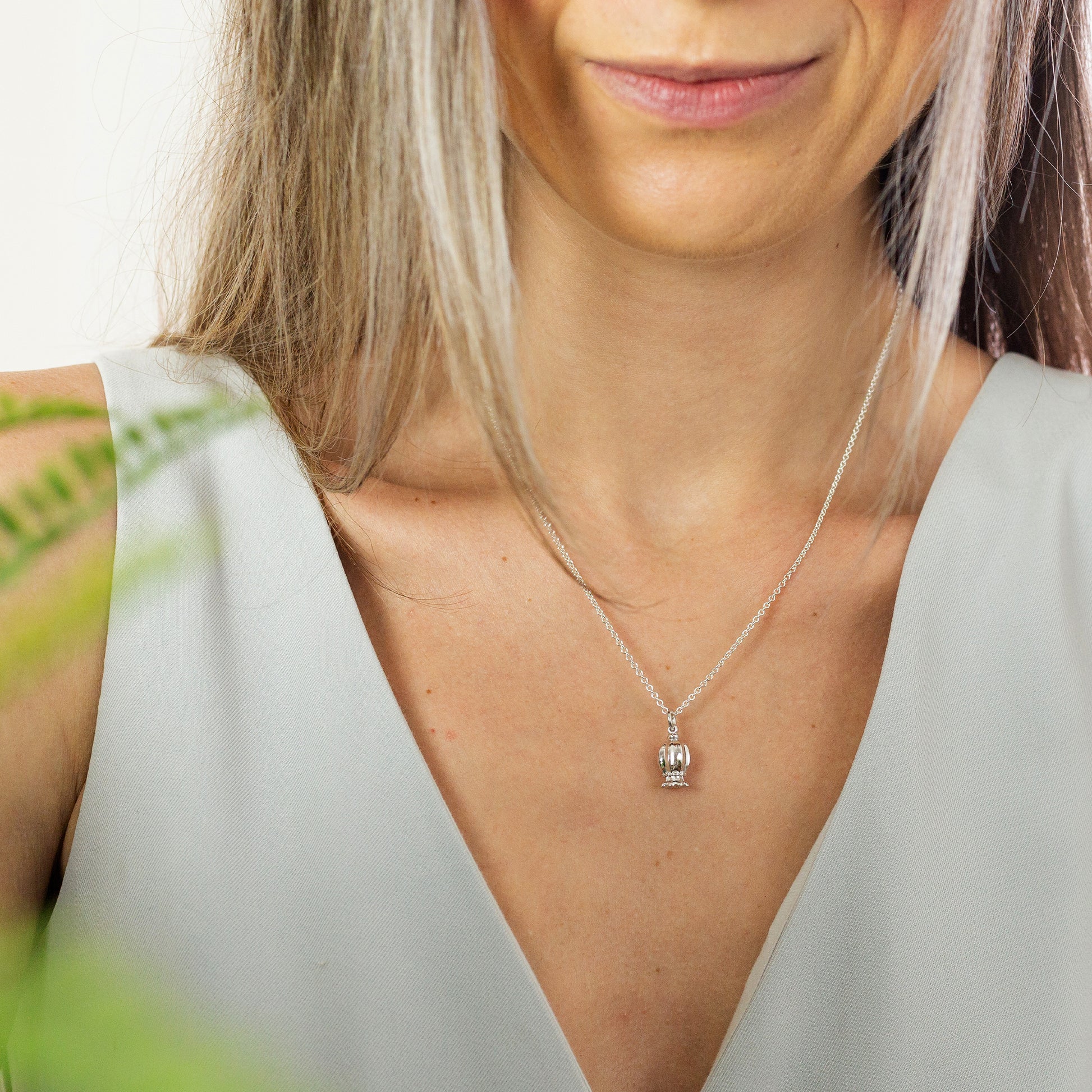 silver poppy seed pendant on silver trace chain