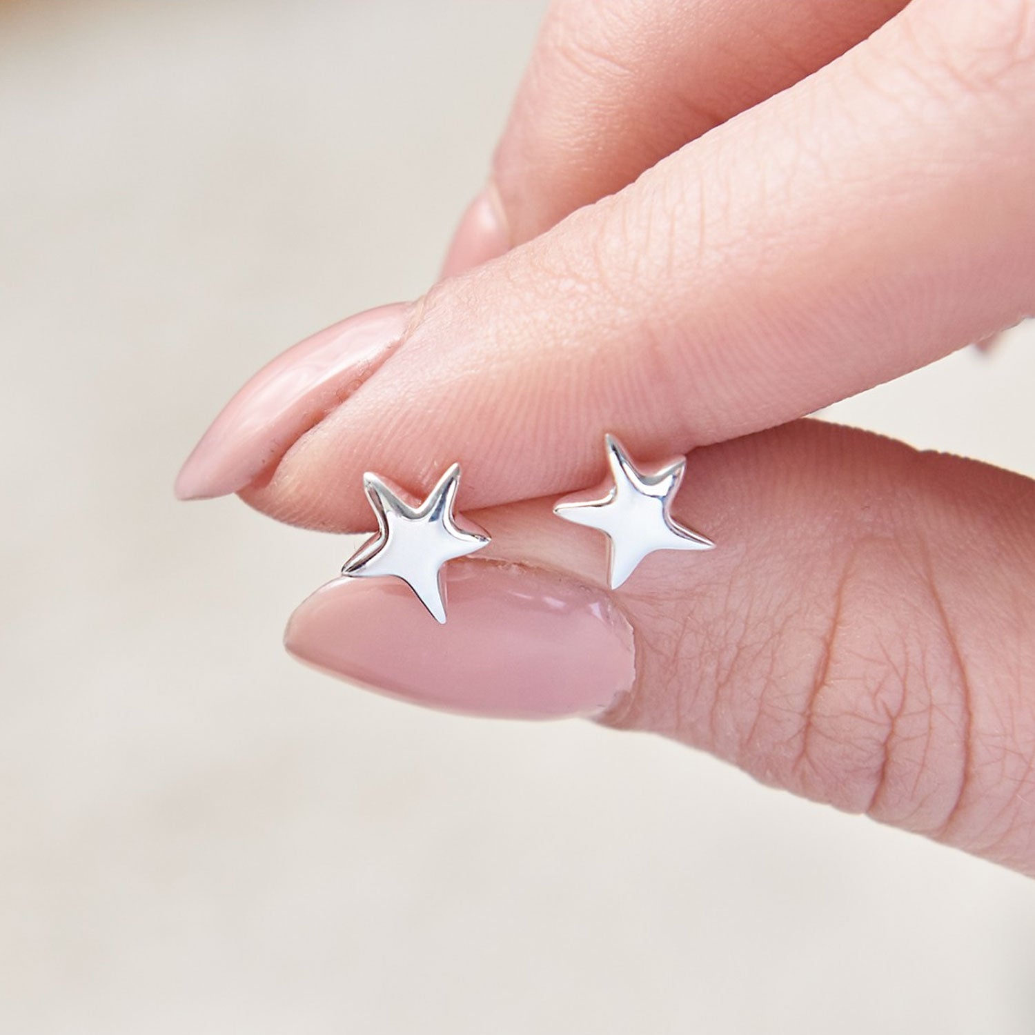 This beautiful, organic shaped pair of silver star studs from designer Scarlett Jewellery