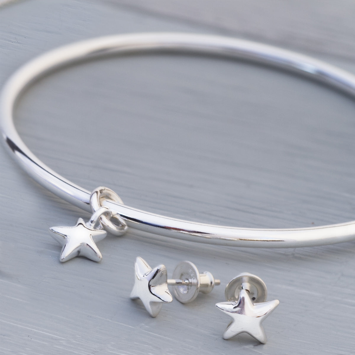 Silver star charm bangle designer and matching star earrings jewellery Scarlett Made in Brighton UK
