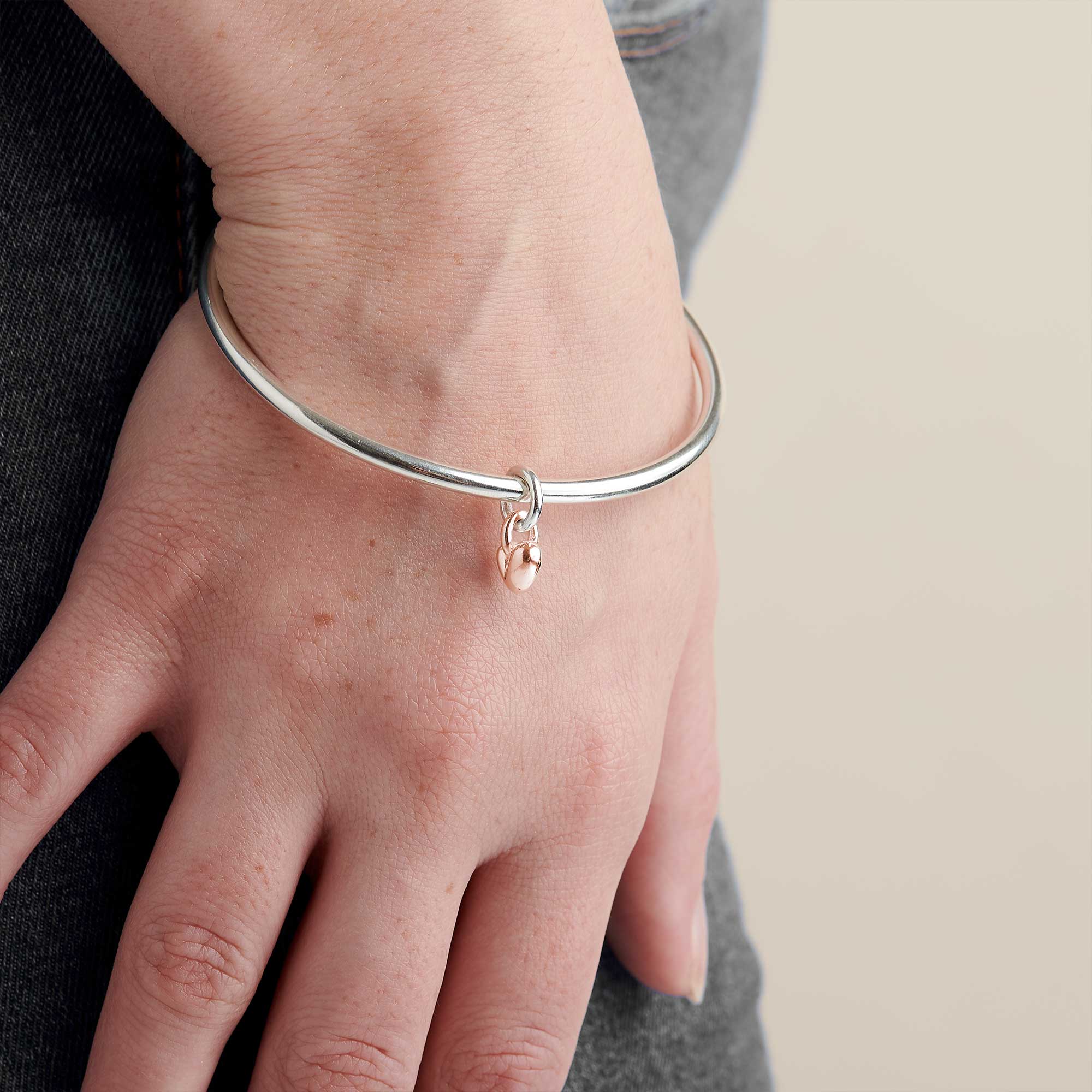 solid silver bangle with recycled rose gold heart charm made in the UK Scarlett Jewellery
